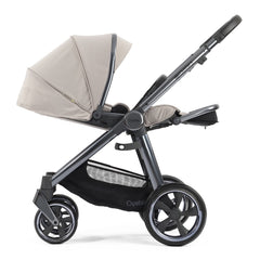 BabyStyle Oyster 3 Gunmetal LUXURY Bundle (Stone) - showing the parent-facing pushchair with its seat fully reclined and its leg rest raised