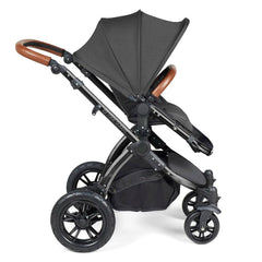 Ickle Bubba Stomp LUXE Travel System with Cirrus Car Seat & ISOFIX Base (Black/Charcoal/Tan) - side view, showing the forward-facing pushchair