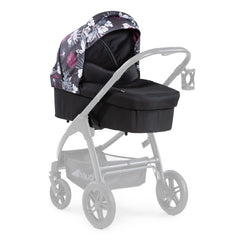 Hauck Saturn Carrycot (Wild Blooms) - quarter view, showing the carrycot fixed onto the Saturn R`s chassis (stroller not included, available separately)