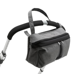 Bugaboo Pushchair Organiser (Grey Melange) - showing the bag being attached to a stroller`s handbar