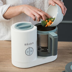 BEABA Babycook Neo (Grey/White) - showing raw vegetables being put into the cooking basket