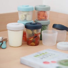 BEABA Toddler Food Storage Starter Pack - 8 Clip Containers - lifestyle image (food, spoons and book not included)