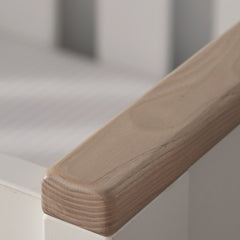 CuddleCo Aylesbury Cot Bed (White & Ash) - lifestyle image, showing the ash accent of the cot
