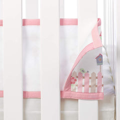 Breathable Baby Cot Bed Set (English Garden) - showing one of the panels being attached to the cot bed sides (cot bed not included)