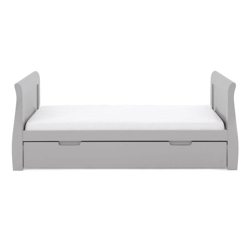 Obaby Stamford Sleigh Cot Bed with Drawer (Warm Grey) - side view, shown here as the junior bed (mattress and bedding not included, available separately)