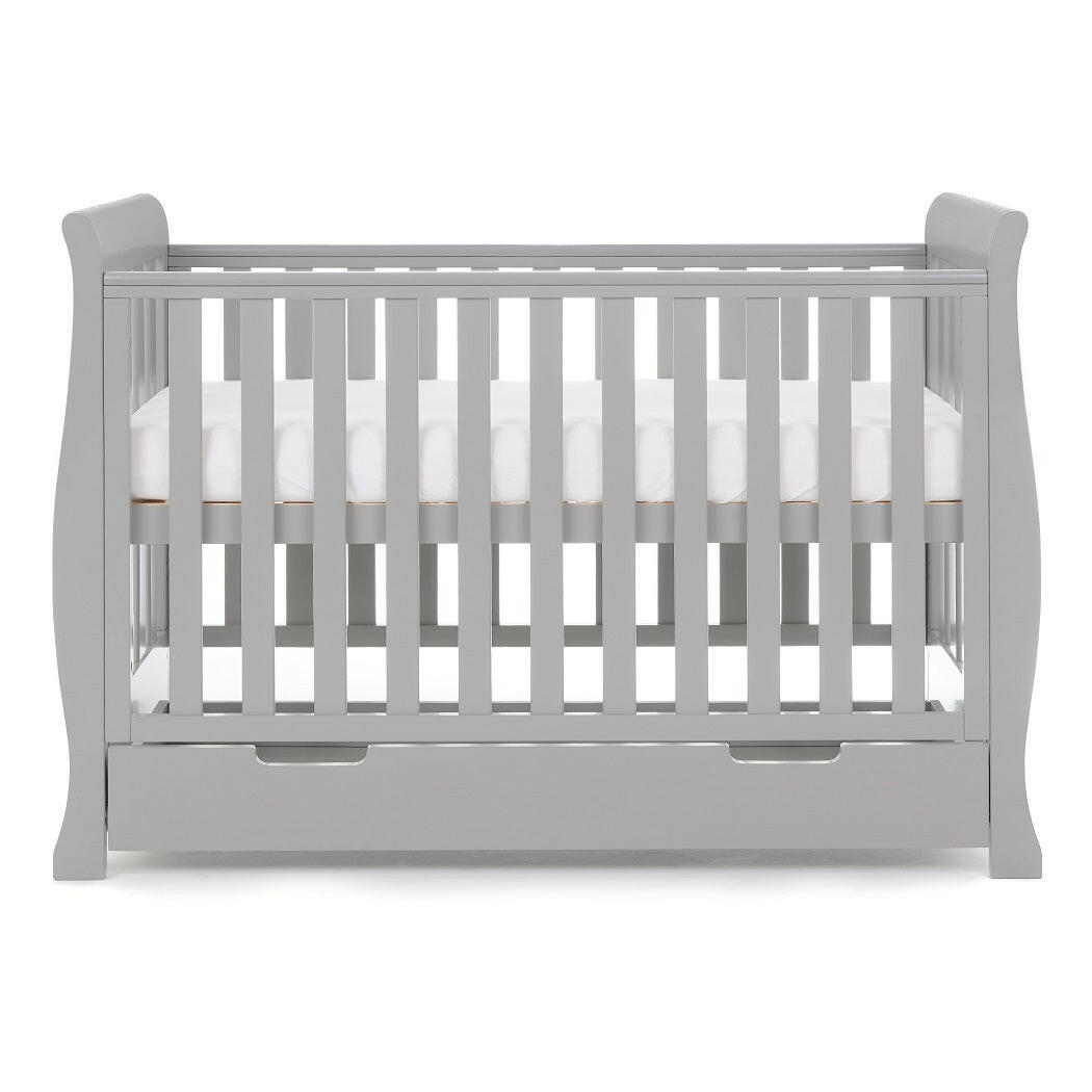 Obaby Stamford MINI Sleigh Cot Bed with Drawer (Warm Grey) - side view, shown here with the mattress base at its highest level (mattress not included)