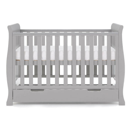 Obaby Stamford MINI Sleigh Cot Bed with Drawer (Warm Grey) - side view, shown here with the mattress base at its highest level (mattress not included)
