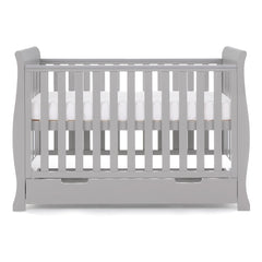 Obaby Stamford MINI Sleigh Cot Bed with Drawer (Warm Grey) - side view, shown here with the mattress base at its highest level (mattress not included)