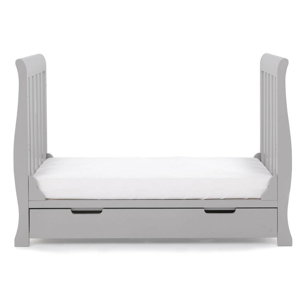Obaby Stamford MINI Sleigh Cot Bed with Drawer (Warm Grey) - side view, shown here as the junior bed (mattress not included)