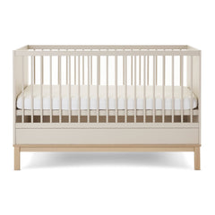 Obaby Astrid Cot Bed - 140x70cm Satin - side view with the mattress base at its middle level