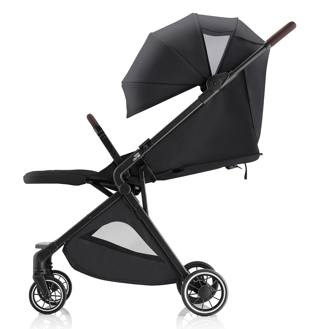 Britax Tira Lightweight Stroller - Carbon Black - side view, with hood extended showing ventilation panel and leg rest raised