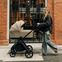 Venicci Claro 2 pram in Almond used outdoors in lifestyle setting