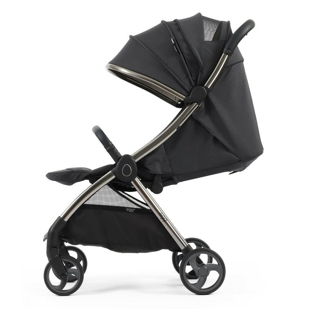 eggZ Stroller - Carbonite - side view with seat fully reclined, leg rest raised and hood extended