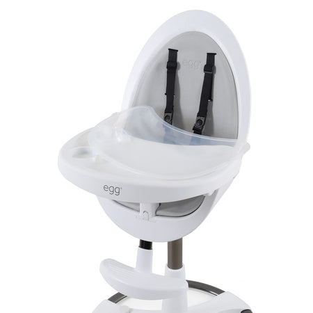 egg White Highchair - close up view with grey seat pad, food trays and safety harness