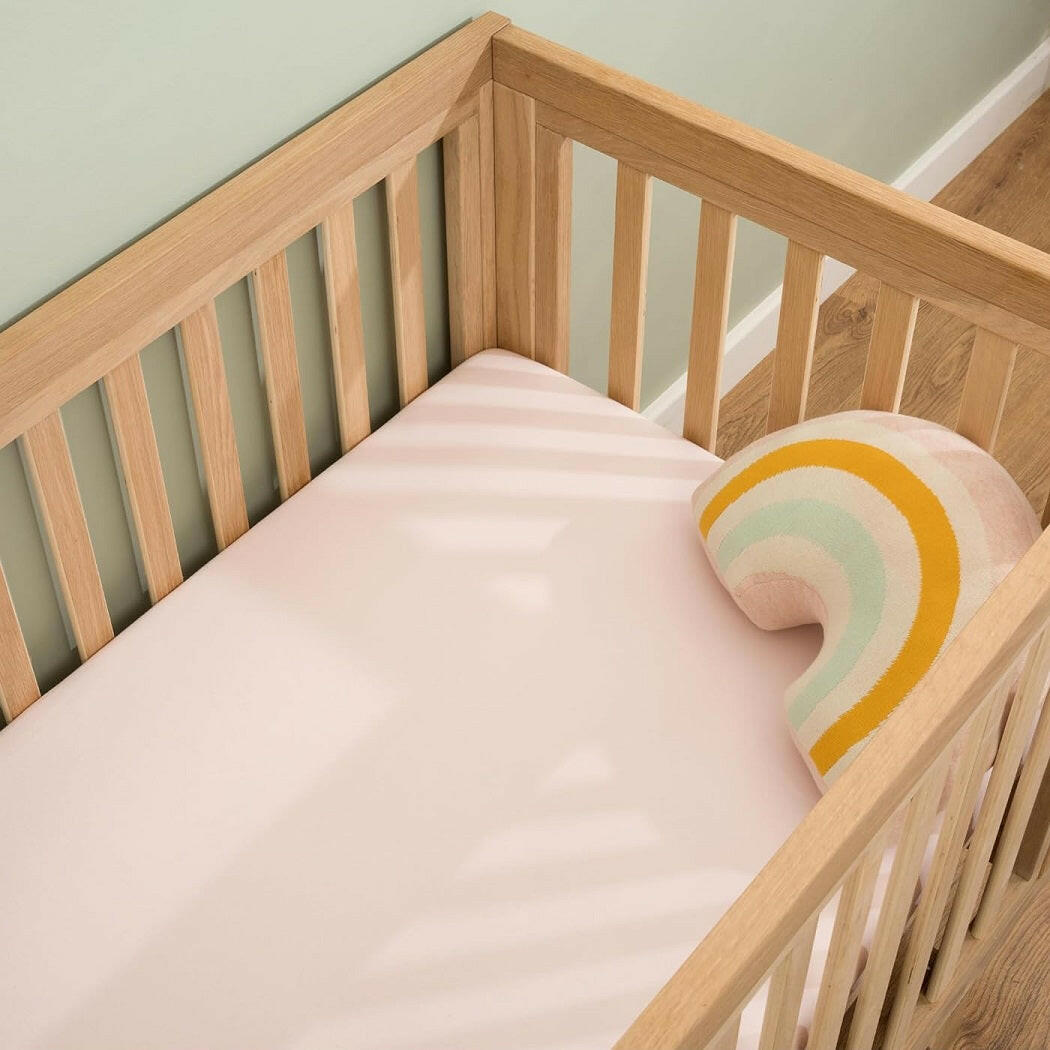 Clair De Lune Fitted Cot Bed Sheets (Pack of 2) - Pink - showing a sheet fitted to a cot bed mattress