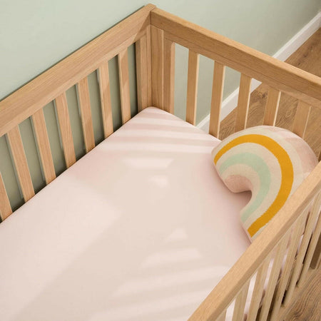 Clair De Lune Fitted Cot Bed Sheets (Pack of 2) - Pink - showing a sheet fitted to a cot bed mattress