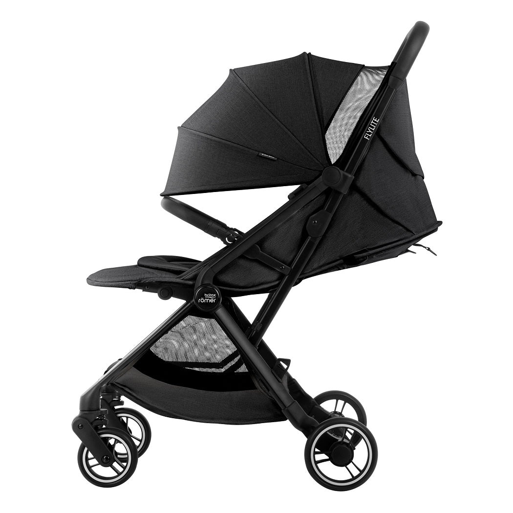 Britax Flylite Travel Stroller - Carbon Black - side view with seat reclined, hood fully extended and leg rest raised