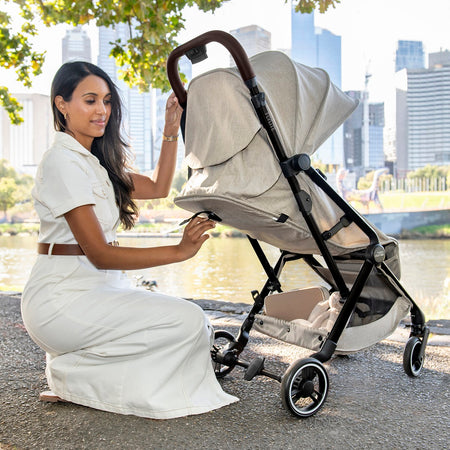 Britax Flylite Travel Stroller - Sage Green - lifestyle image, shown with seat reclined