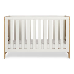 Obaby Nika Cot Bed Oak & White - side view, mattress base at lowest level
