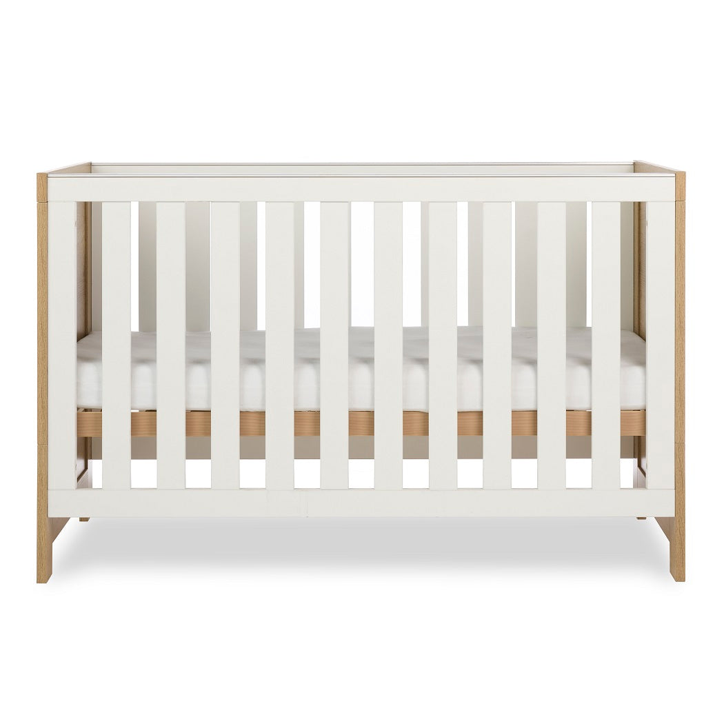 Obaby Nika Cot Bed Oak & White - side view, mattress base at middle level