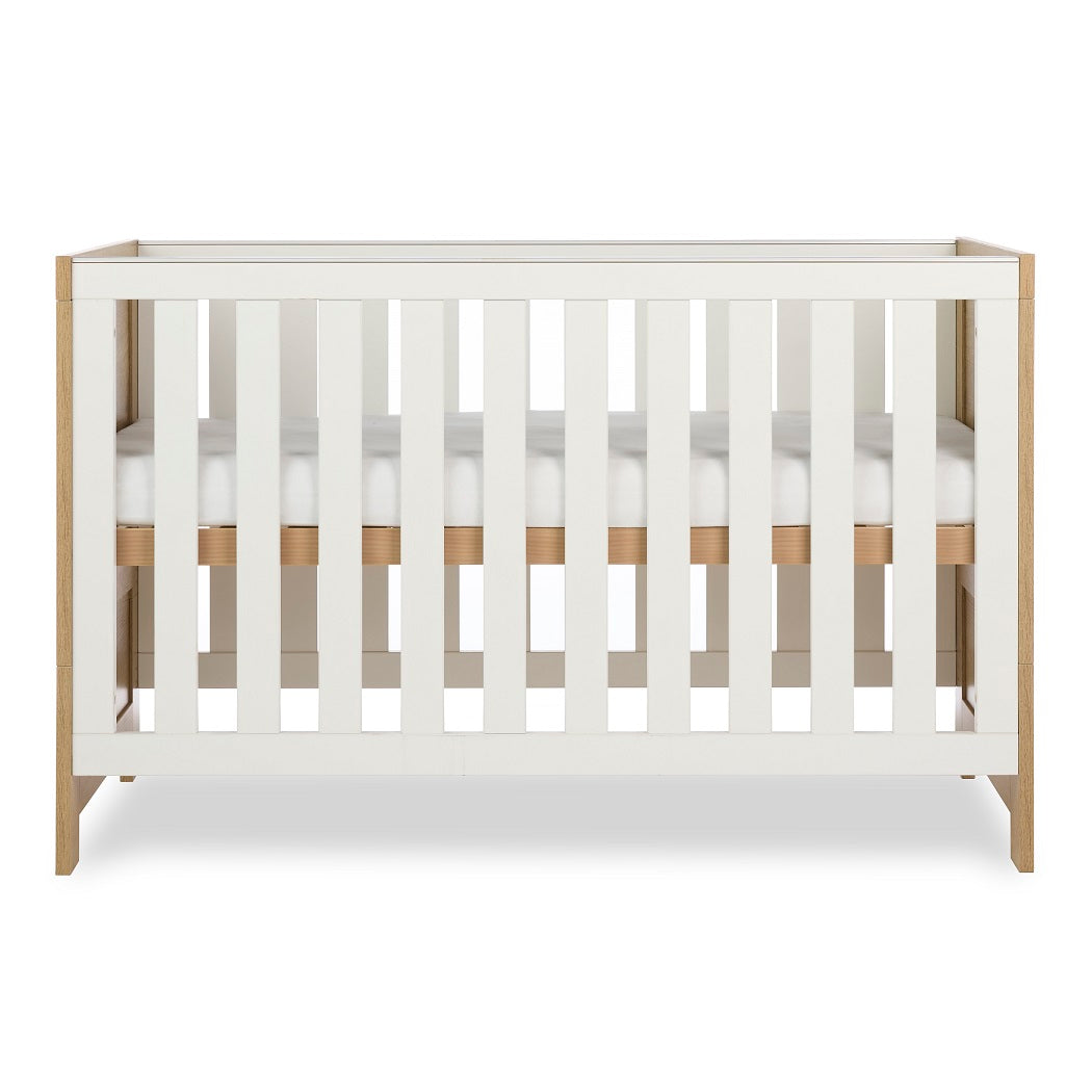 Obaby Nika Cot Bed Oak & White - side view, mattress base at highest level