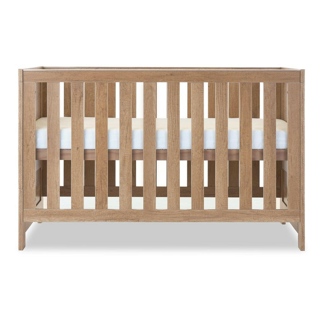 Obaby Nika Cot Bed - Oak - side view, mattress base at highest level