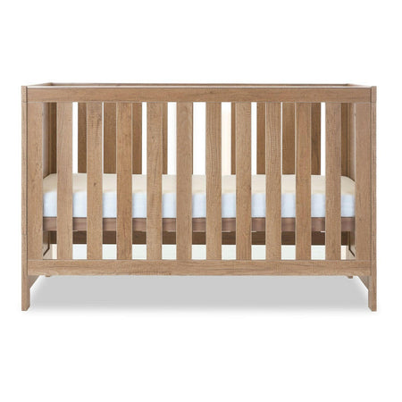Obaby Nika Cot Bed (Oak) - side view, mattress base at middle level