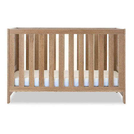Obaby Nika Cot Bed (Oak) - side view, mattress base at lowest level