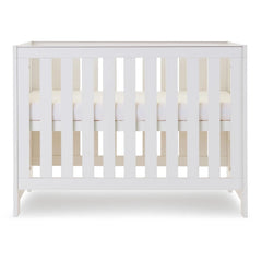 Obaby Nika MINI Cot - White Wash - shown with mattress base at middle level
