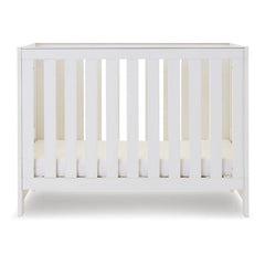 Obaby Nika MINI Cot - White Wash - shown with mattress base at lowest level