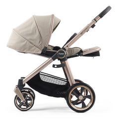 BabyStyle Oyster 3 Champagne ESSENTIAL Bundle (Creme Brulee) - side view, showing the parent-facing pushchair with the seat fully reclined and leg rest raised