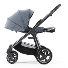 BabyStyle Oyster 3 Gunmetal ESSENTIAL Bundle (Dream Blue) - side view, showing the parent-facing pushchair with the seat fully reclined and leg rest raised