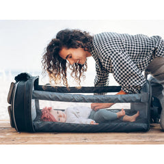 Bizzi Grownin Travel Crib Changing Bag - The POD® (Chelsea Black) - lifestyle image, showing the crib being enjoyed by an infant