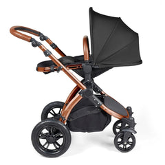 Ickle Bubba Stomp LUXE Travel System with Stratus Car Seat & ISOFIX Base (Bronze/Midnight/Tan) - showing the seat unit and chassis together as the pushchair in parent-facing mode with the seat reclined