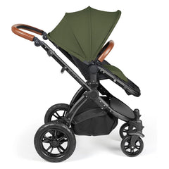Ickle Bubba Stomp LUXE Travel System with Stratus Car Seat & ISOFIX Base (Black/Woodland/Tan) - showing the pushchair in forward-facing mode