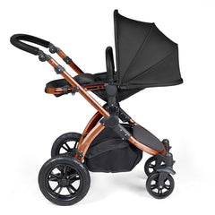 Ickle Bubba Stomp LUXE Travel System with Stratus Car Seat & ISOFIX Base (Bronze/Midnight/Black) - showing the seat unit and chassis together as the pushchair in parent-facing mode with the seat reclined