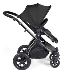 Ickle Bubba Stomp LUXE Travel System with Stratus Car Seat & ISOFIX Base (Black/Midnight/Black) - side view, showing the forward-facing pushchair