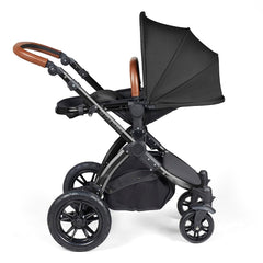 Ickle Bubba Stomp LUXE Travel System - Black/Midnight/Tan - showing the seat unit and chassis together as the pushchair in parent-facing mode with the seat reclined
