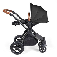 Ickle Bubba Stomp LUXE Travel System with Stratus Car Seat & ISOFIX Base (Black/Midnight/Tan) - showing the seat unit and chassis together as the pushchair in parent-facing mode with the seat reclined