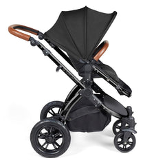 Ickle Bubba Stomp LUXE Travel System with Stratus Car Seat & ISOFIX Base (Black/Midnight/Tan) - side view, showing the forward-facing pushchair