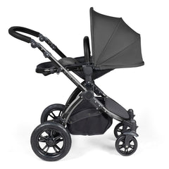 Ickle Bubba Stomp LUXE Travel System with Stratus Car Seat & ISOFIX Base (Black/Charcoal/Black) - showing the seat unit and chassis together as the pushchair in parent-facing mode with the seat reclined