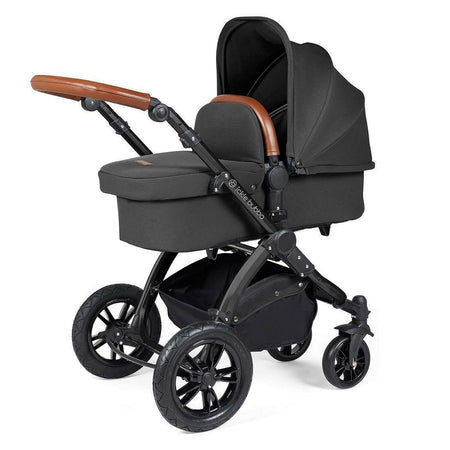 Ickle Bubba Stomp LUXE Travel System with Cirrus Car Seat & ISOFIX Base (Black/Charcoal/Tan) - showing the carrycot and chassis together as the pram