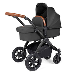 Ickle Bubba Stomp LUXE Travel System with Stratus Car Seat & ISOFIX Base (Black/Charcoal/Tan) - showing the carrycot and chassis together as the pram