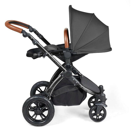 Ickle Bubba Stomp LUXE Travel System with Cirrus Car Seat & ISOFIX Base (Black/Charcoal/Tan) - showing the seat unit and chassis together as the pushchair in parent-facing mode with the seat reclined