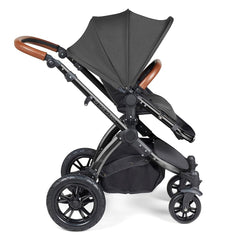 Ickle Bubba Stomp LUXE Travel System with Stratus Car Seat & ISOFIX Base (Black/Charcoal/Tan) - side view, showing the forward-facing pushchair