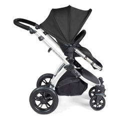 Ickle Bubba Stomp LUXE Travel System with Stratus Car Seat & ISOFIX Base (Silver/Midnight/Black) - side view, showing the forward-facing pushchair with the seat upright