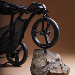 Mountain Buggy Swift V4 Pushchair - swivelling front wheel sitting on a rock