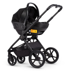 Venicci Tinum EDGE 3-in-1 Travel System with ISOFIX Base (Moss) - showing the included Venicci Engo Car Seat attached to the chassis using the included adaptors