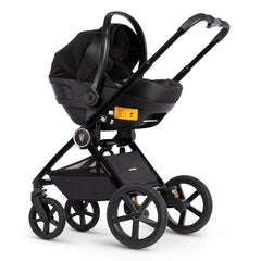 Venicci Upline Travel System 3-in-1 (All Black) - showing the Engo i-Size Car Seat attached to the pushchair chassis using the included car seat adaptors