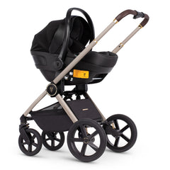 Venicci Upline Travel System 3-in-1 (Stone Beige) - showing the Engo i-Size Car Seat attached to the pushchair chassis using the included car seat adaptors